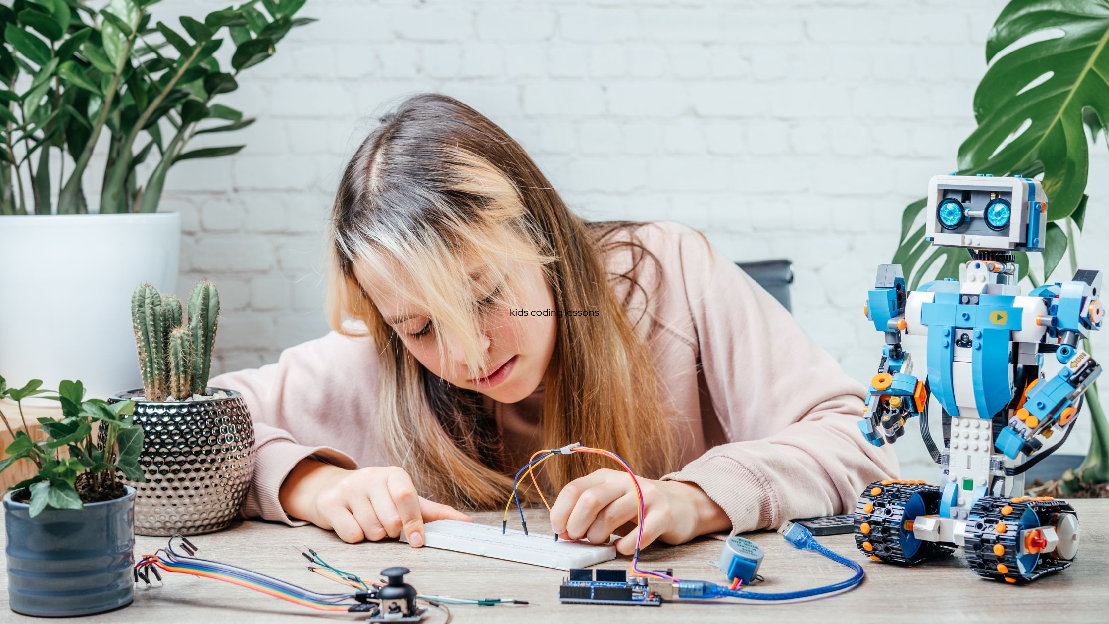 a girl making robot wire connection