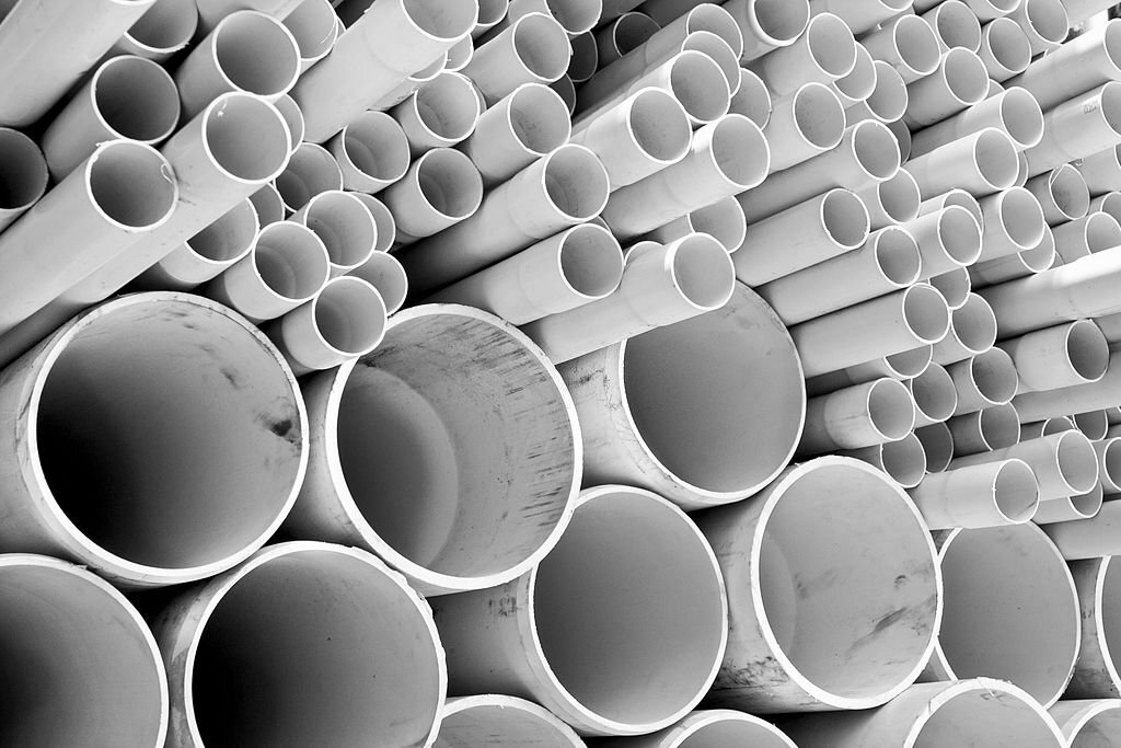 Size of PVC pipes stacked in construction site.